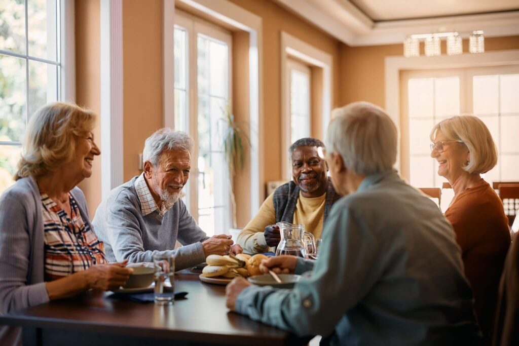 a group of senior adults having a  meal together